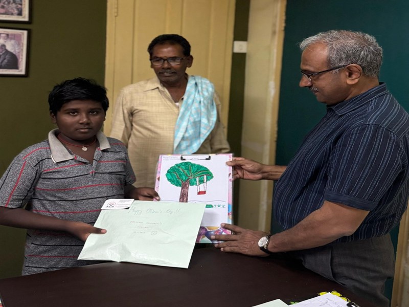 A child receiving a certificate for his drawing at the hospital